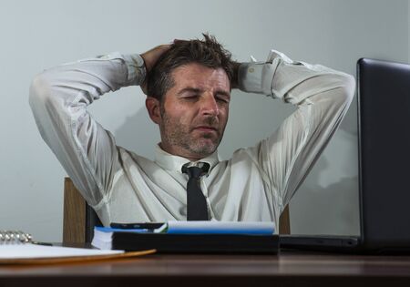 desperate financial executive man in stress - corporate business lifestyle portrait of stressed and overwhelmed businessman working frustrated and anxious having depression problemの写真素材