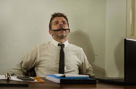 desperate financial executive man in stress - corporate business lifestyle portrait of stressed and overwhelmed businessman working frustrated and anxious having depression problemの写真素材