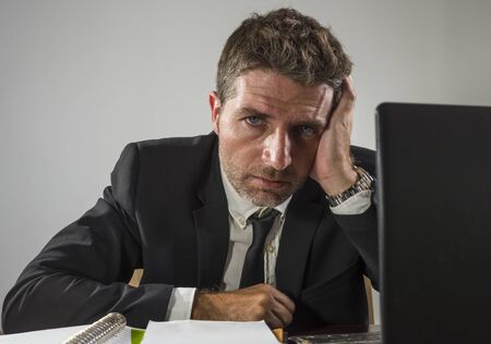 exhausted financial executive man suffering stress - corporate business lifestyle portrait of stressed and tired businessman working frustrated having problem feeling upset and overworkedの写真素材
