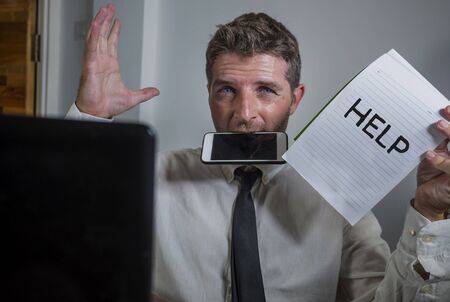 business lifestyle portrait of depressed and overwhelmed attractive man working at office computer...