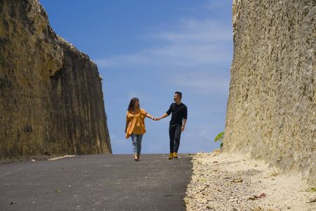 young happy and beautiful Asian Chinese couple in love enjoying outdoors romantic journey walking in...