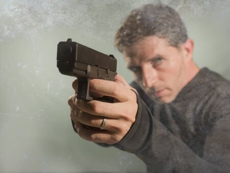 grunge cinematic portrait of attractive and dangerous looking hitman or secret service especial...