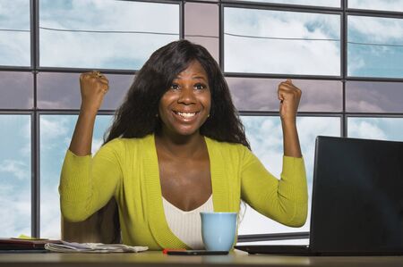 young happy and attractive black afro American business woman smiling confident working at office...