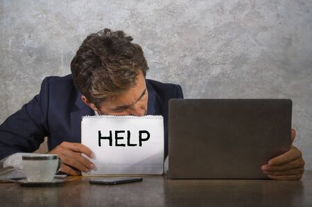 depressed and stressed attractive hispanic man in suit and tie working overwhelmed office computer...