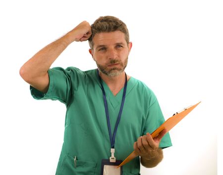 portrait of young stressed and overworked medicine doctor or nurse man holding clipboard medical...