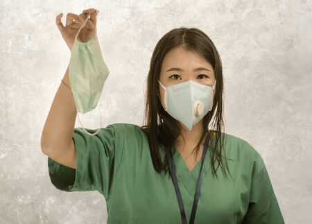 Coronavirus outbreak - young beautiful Asian Chinese medicine doctor woman or hospital nurse recommend use of protective face mask in prevention vs virus infection in health careの写真素材