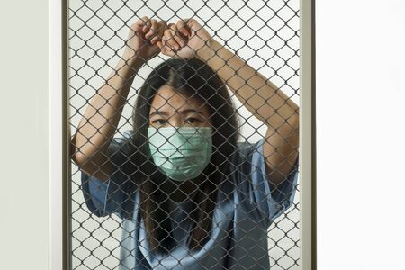 dramatic portrait of young Asian Chinese woman infected with virus victim of contagious disease or...