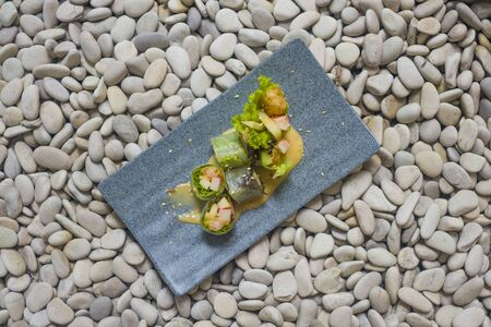 Japan gourmet cuisine -  delicious and delicate dish of Japanese sushi rolls in slate on stone...
