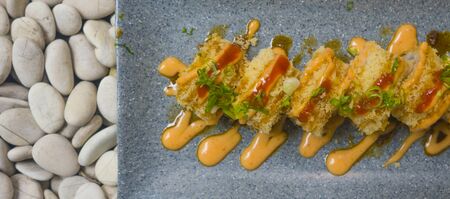 Japan gourmet cuisine -  delicious and delicate dish of Japanese sushi rolls in slate on stone...