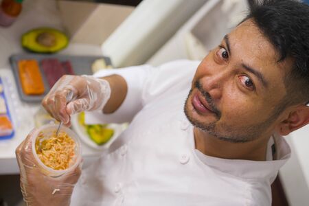 lifestyle portrait of Asian home cook man or professional chief preparing for cooking and making...