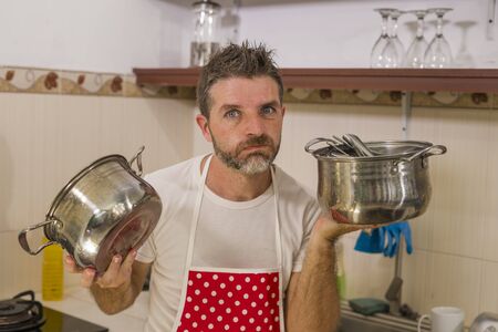 domestic chores stress - lifestyle portrait of young attractive overworked and stressed home cook...