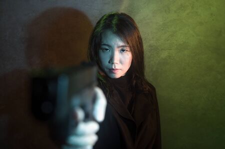 edgy cinematic portrait of young attractive and dangerous special agent woman or Asian mobster girl...