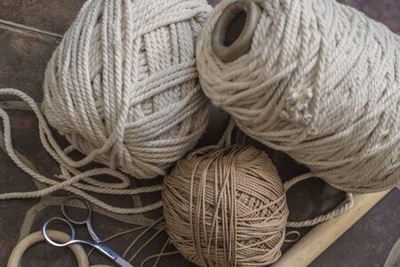 macramŽ still life detail of rope texture - group of cords and threads with scissors to handcraft...