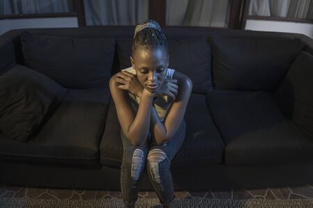 Millennial generation afro American girl at night suffering depression - young attractive sad and...