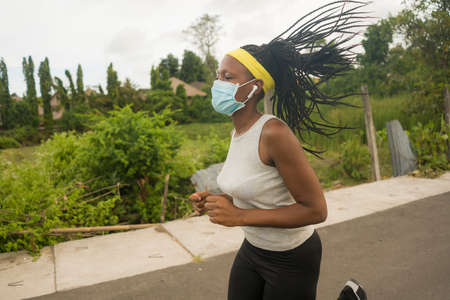 post quarantine runner girl enjoying outdoors workout - young attractive and fit black African...
