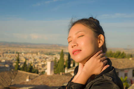 lifestyle portrait of young beautiful and happy Asian Chinese tourist woman enjoying Summer holidays in Europe walking cheerful visiting beautiful Alhambra in Granada Spainの写真素材