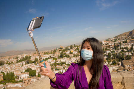 new normal travel and tourism - young happy and beautiful Asian Chinese woman in anti virus mask...