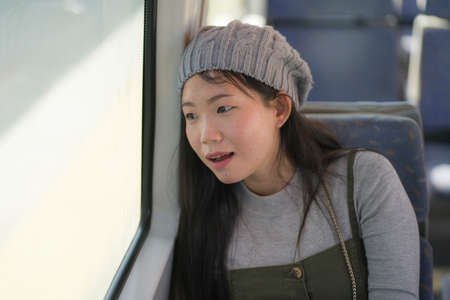 lifestyle portrait of young happy and beautiful Asian Japanese woman excited and cheerful looking...