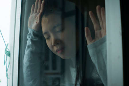 young sad and depressed Asian Japanese girl scared and worried during covid19 lockdown and stay home...