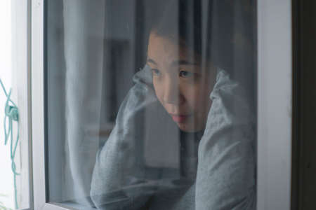 young sad and depressed Asian Korean girl scared and worried during covid19 lockdown and stay home...