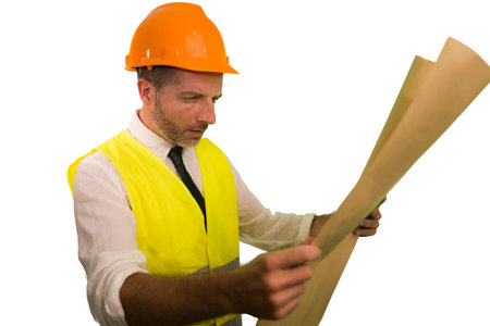 successful engineer in hardhat and vest - young efficient and attractive builder or contractor...