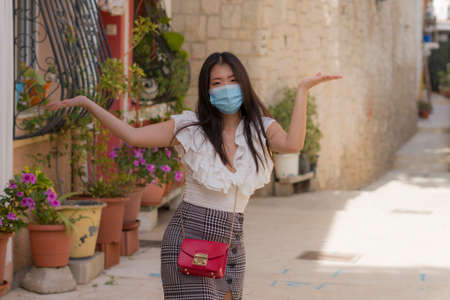 Asian woman touring in Andalusia Spain during covid19 - young happy and beautiful Japanese girl in...