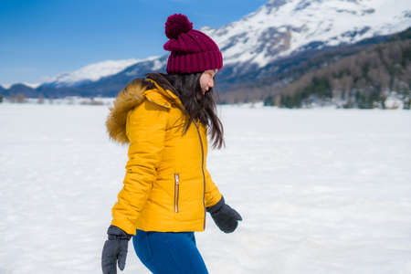 winter lifestyle portrait of young happy and attractive Asian Japanese woman at beautiful snow...