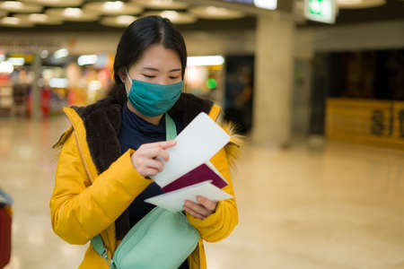 Asian woman flying in covid19 times - lifestyle portrait of young happy and pretty Japanese girl in...