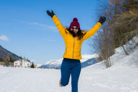Winter holidays in the snow - lifestyle portrait of young happy and beautiful Asian Japanese girl...