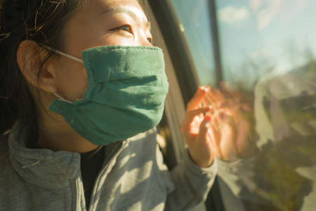 train travel in times  - young happy and cute Asian Korean woman in  face mask traveling on railcar...