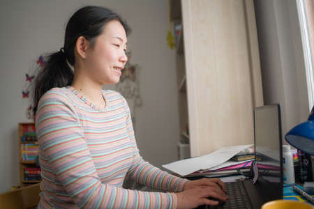 telework and remote job - lifestyle portrait of young happy and beautiful Asian Chinese woman...