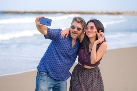 Young couple enjoying time at the beachの写真素材