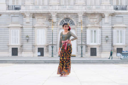 young happy Indonesian woman from Bali having vacation in Europe - beautiful and cheerful Balinese...