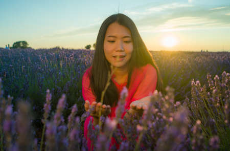 young happy and beautiful Asian Japanese woman in Summer dress enjoying free and playful at purple...