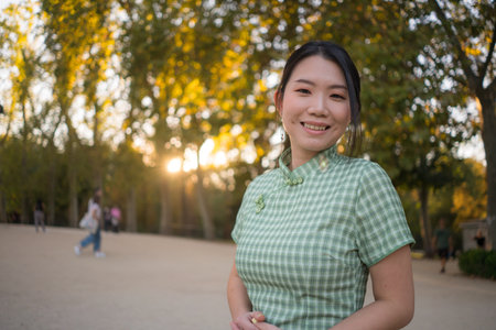lifestyle portrait of young happy and attractive Asian Japanese woman relaxed taking a walk on city...