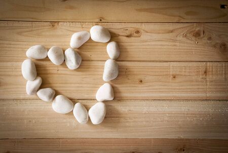 Heart shape stone- love on pallet woodの写真素材