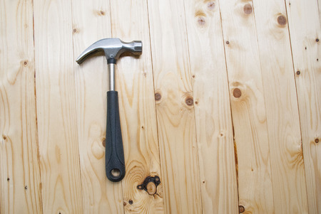 Hammer on pallet wood background