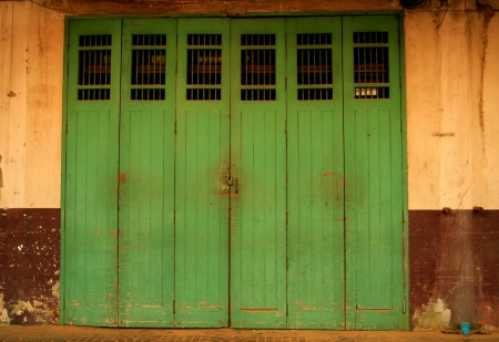 the old green door at Charoen Krung Rd.near golden mountain in the bangkokの写真素材