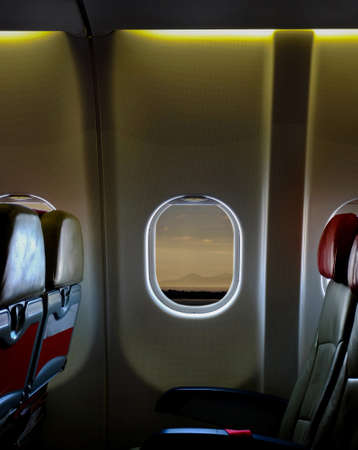 airplane seat inside the cabin plane. View of the sky from the airplane window,empty seatsの写真素材