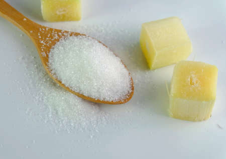 sugar on the spoon with sugarcane cubeの写真素材