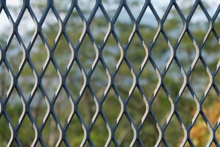 steel wire mesh fence with blurred backgroundの写真素材