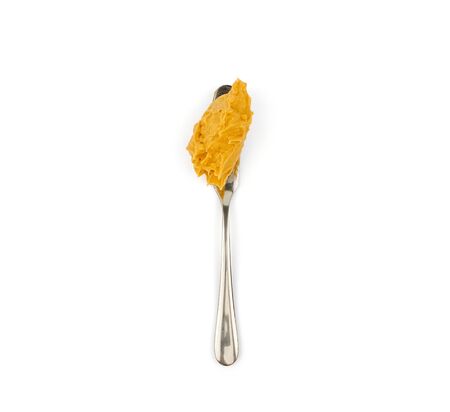 brown peanut butter on the spoon on white backgroundの写真素材