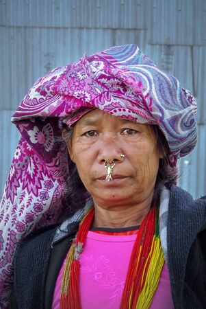 Num, Sankhuwasabha District, Nepal - 11/17/2017: Close up of an indigenous Rai woman with traditional jewelry scorpion nose ring and colorful clothes, East Nepal mountain regionのeditorial素材