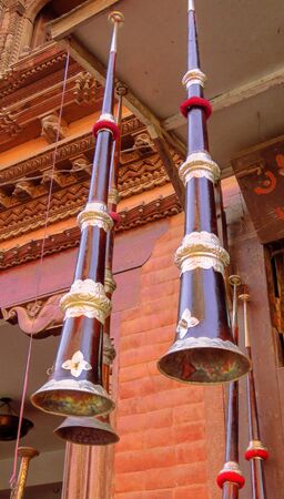 Tibetan horn hanging from the ceiling in front of a music store in Bhaktapur, Nepal