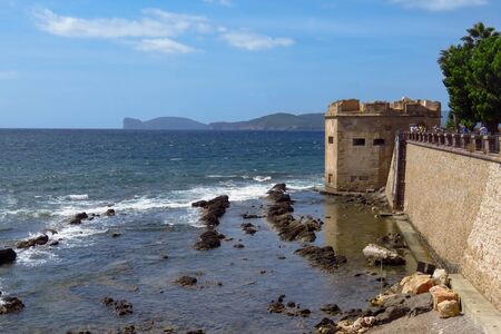 Alghero city wall, fortress, promenade and the Mediterranean Sea, a popular tourist spot in...