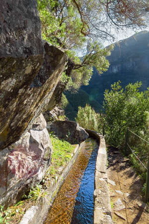 Rabacal 25 fountains levada (irrigation channels) walk, following the water stream on a sunny day,...