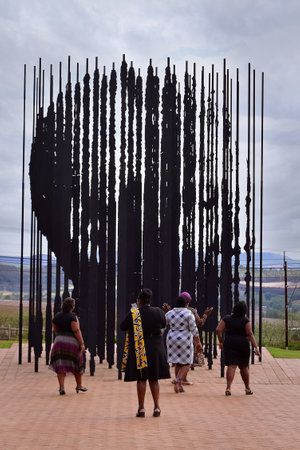 Howick, South Africa - November 2, 2019: Black women walking up to the sculpture showing the face of Nelson Mandela when seen from a certain angle. Artwork created by Marco Cianfanelliのeditorial素材