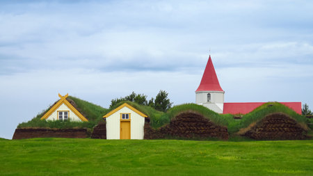 Glaumbaer scenic traditional village with red roof church, houses covered with turf and grass growing on the roof, Iceland, Europeの写真素材