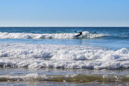 Surfing ocean waves, a fun water sports activity at Praia do Castelejo beach, Vila do Bispo, Algarve, Portugal, Europeの写真素材