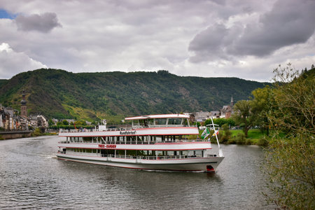 Cochem, Germany - August 26 2021: Tourist boat excursion cruise on the Moselle on a cloudy day.のeditorial素材